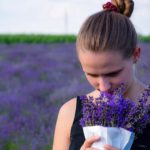 lady smelling lavender in field