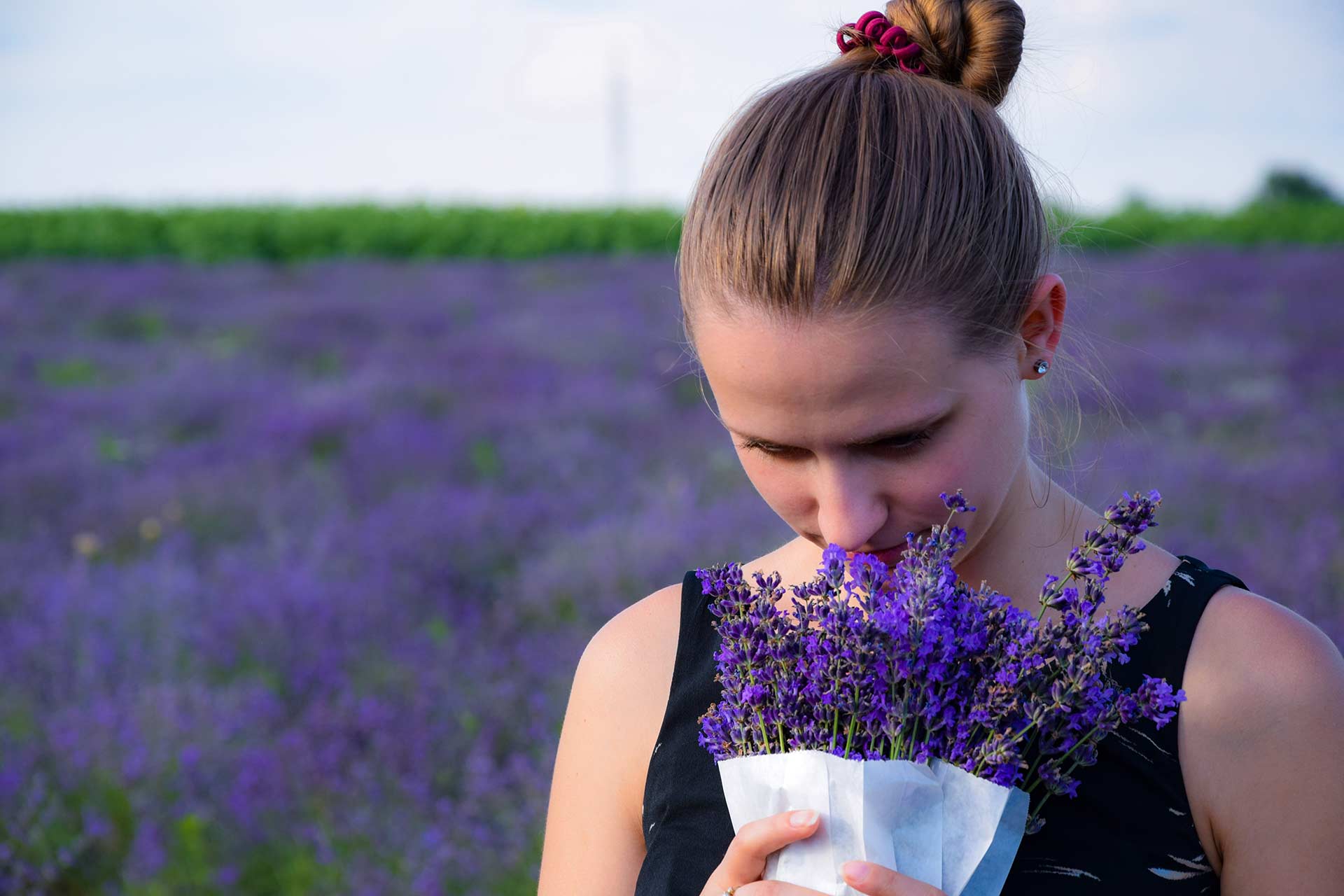 lady smelling lavender in field