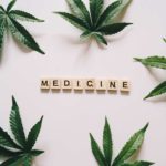 scrabble letters spell medicine with cannabis leaf surrounding