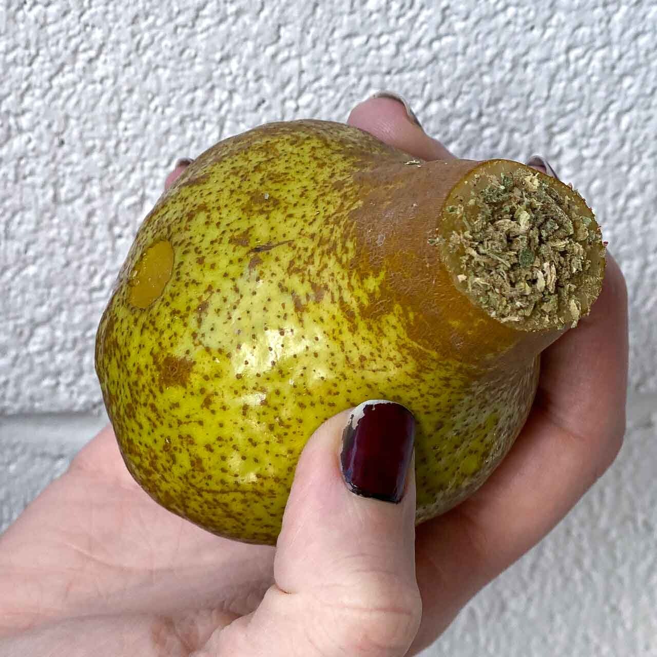Hand Holding a DIY Pear Weed Pipe