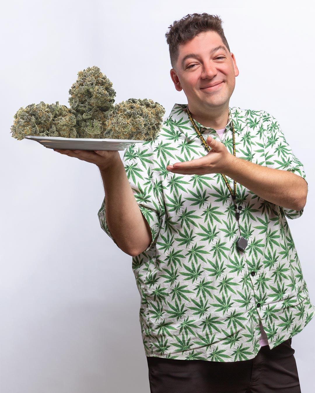 Zach York, first officially certified Ganjier holding a plate of cannabis flower